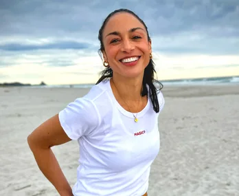 sonia gray smiling standing on beach