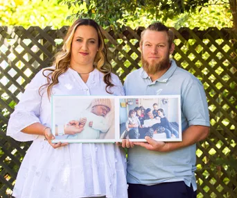 kylie ben collins holding pictures of their stillborn son
