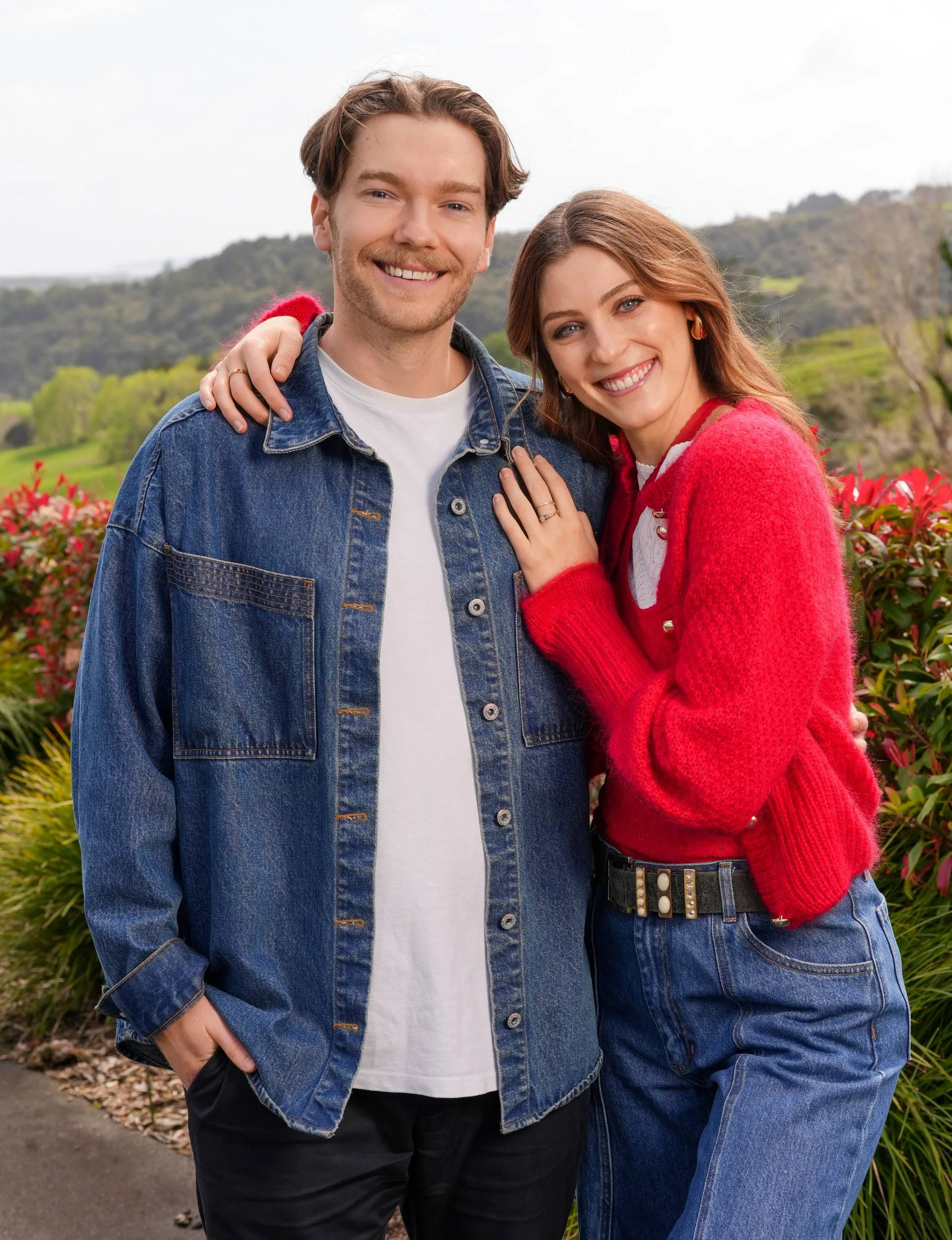 couple posing with denim shirt and red cardigan 