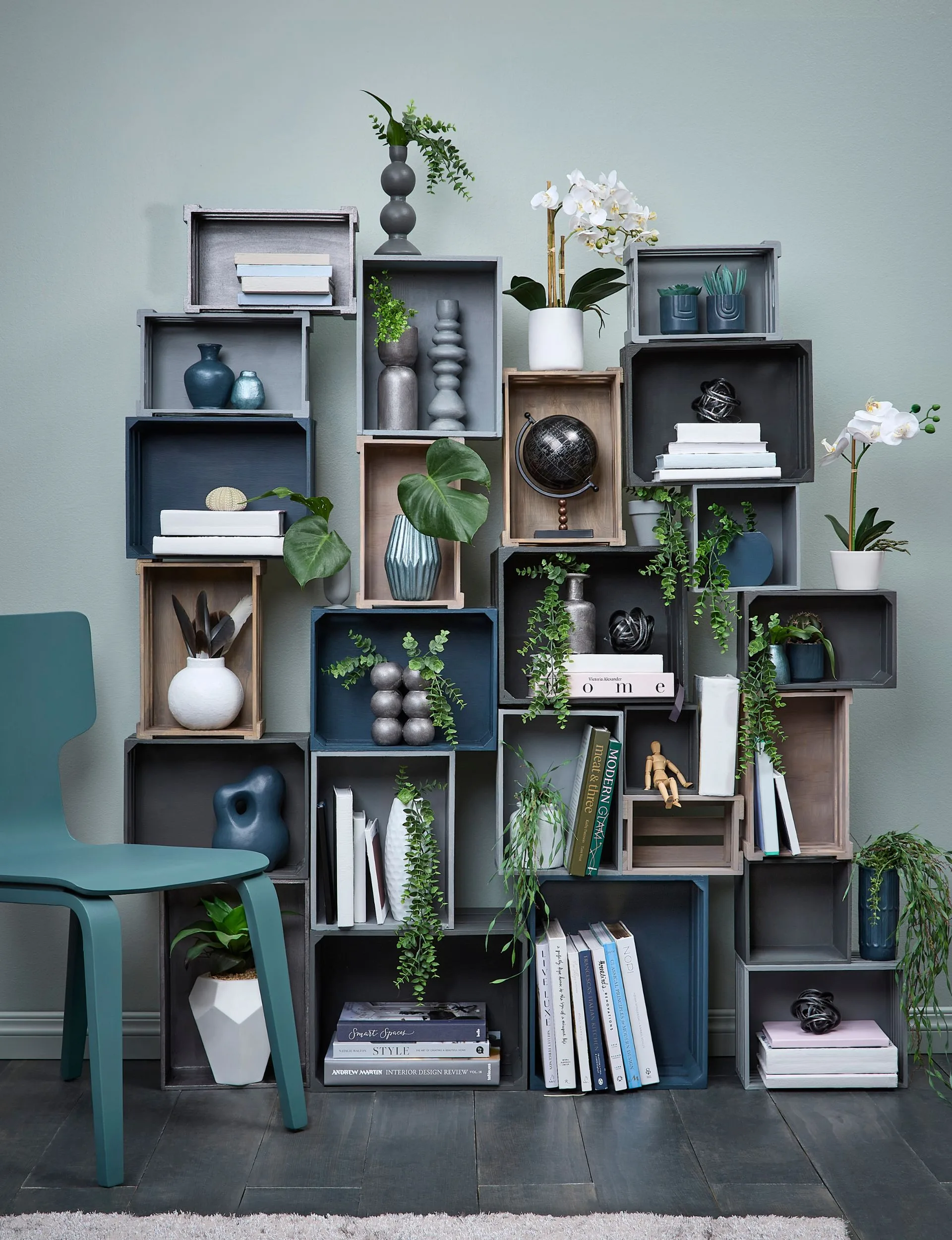 Moveable storage created using different size crates painted in a range of black, greys, browns and blues