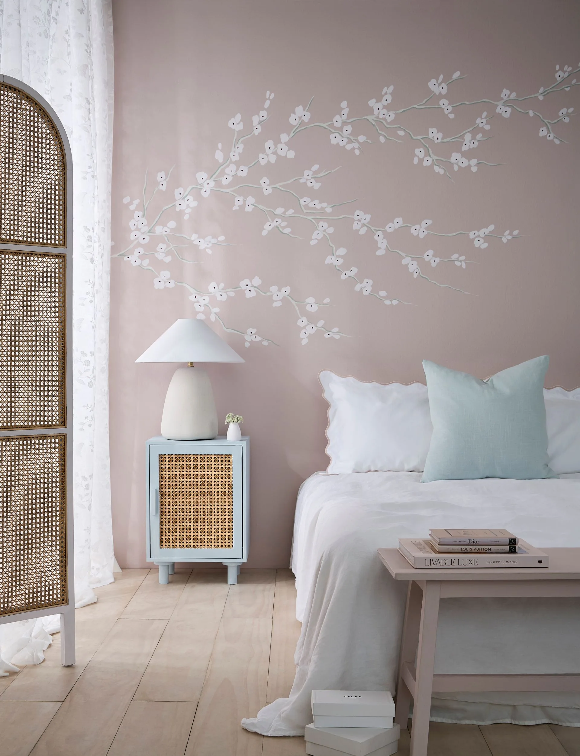 White floral painted mural on a dusty pink wall gives this teen bedroom a sophisticated touch