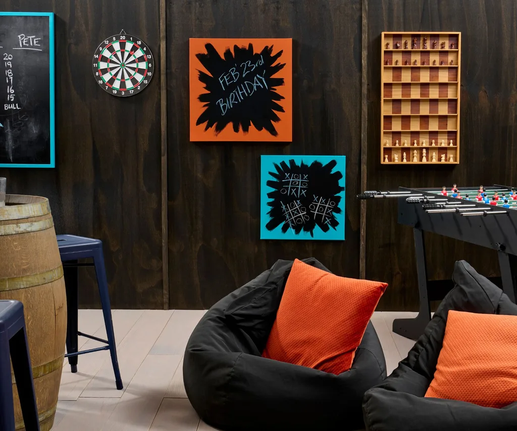 Black stained walls have been brightened with accents of oranges and blues in the decor