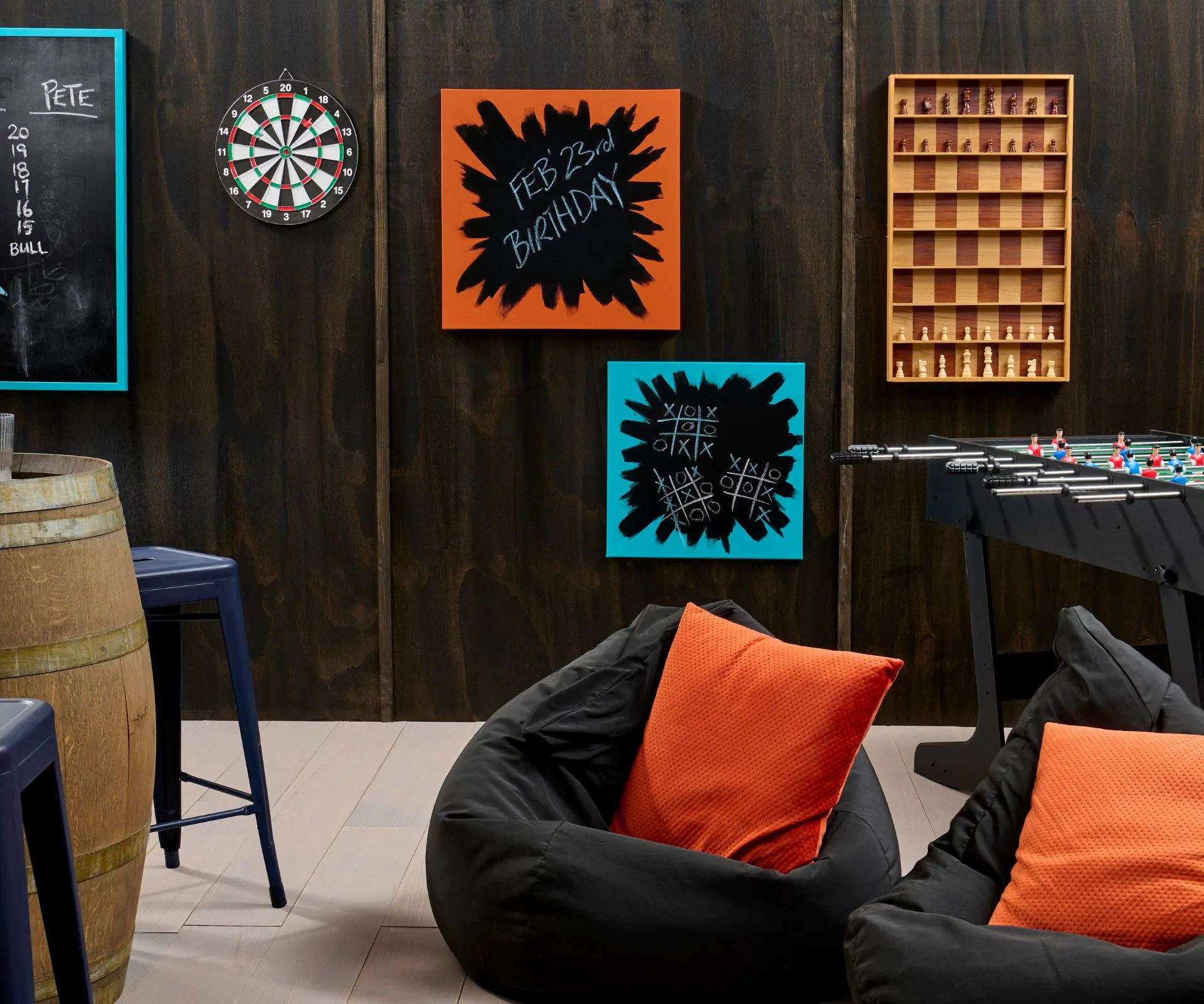 Black stained walls have been brightened with accents of oranges and blues in the decor