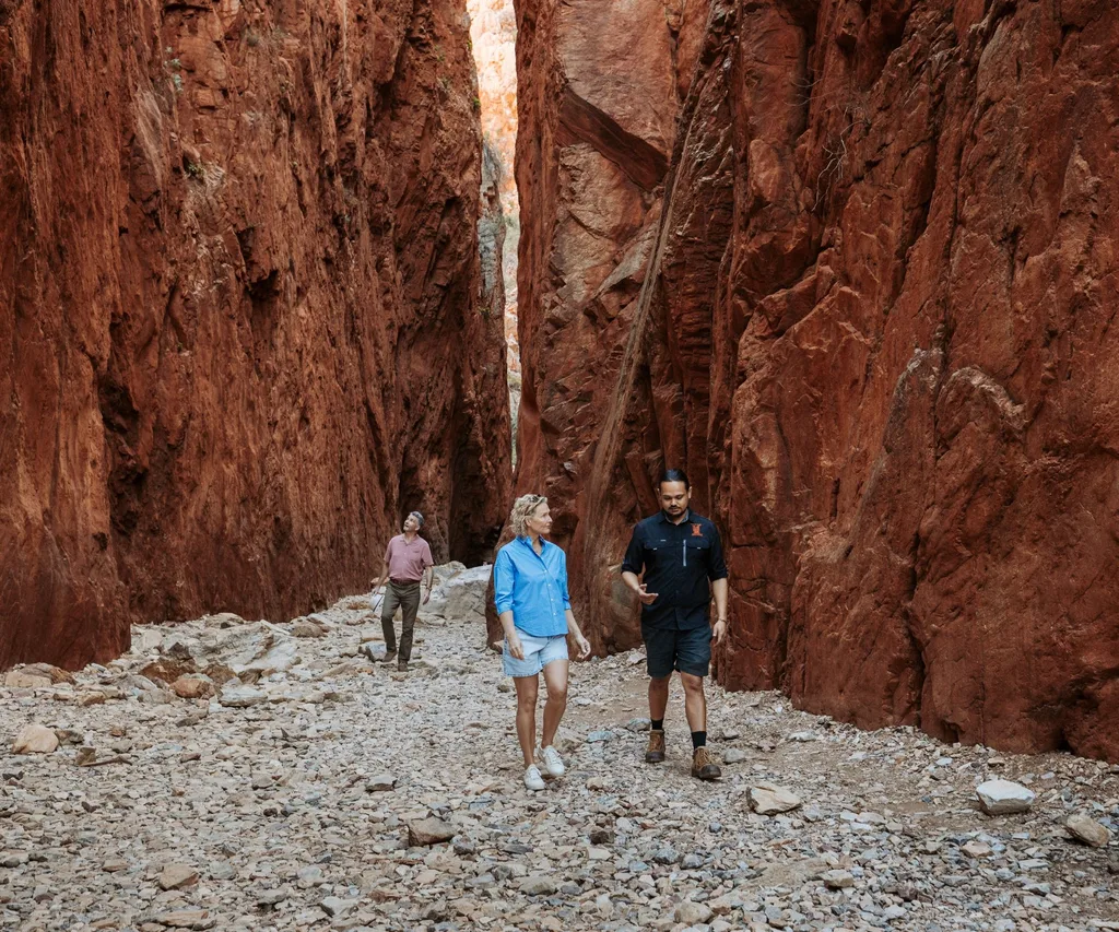 A couple taking a guided tour of Standley Chasm as part of their rail journey