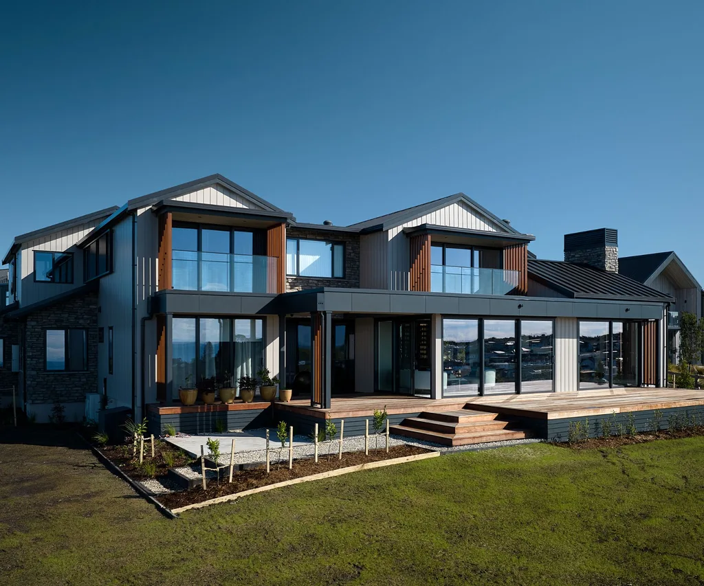 The exterior of this Long Bay home is mostly aluminium cladding, with some Alexandra stone used as a feature
