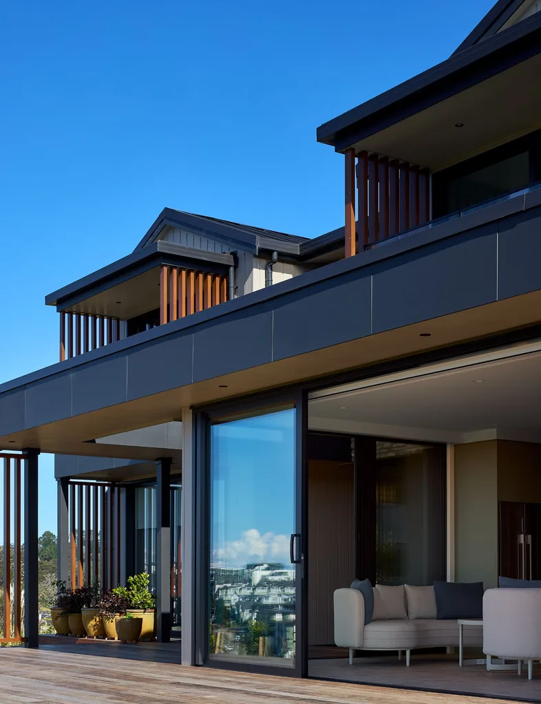 The sliding doors of this Long Bay home are from the Vantage Metro Series