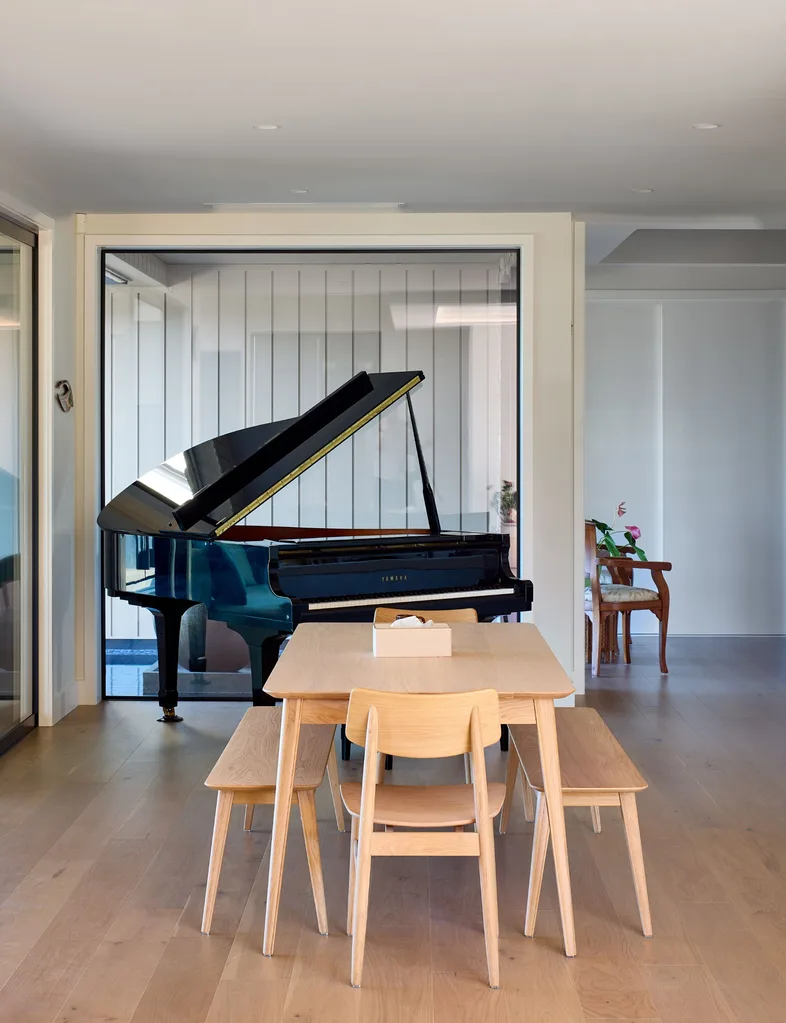 The baby grand piano fits comfortably in the casual dining room
