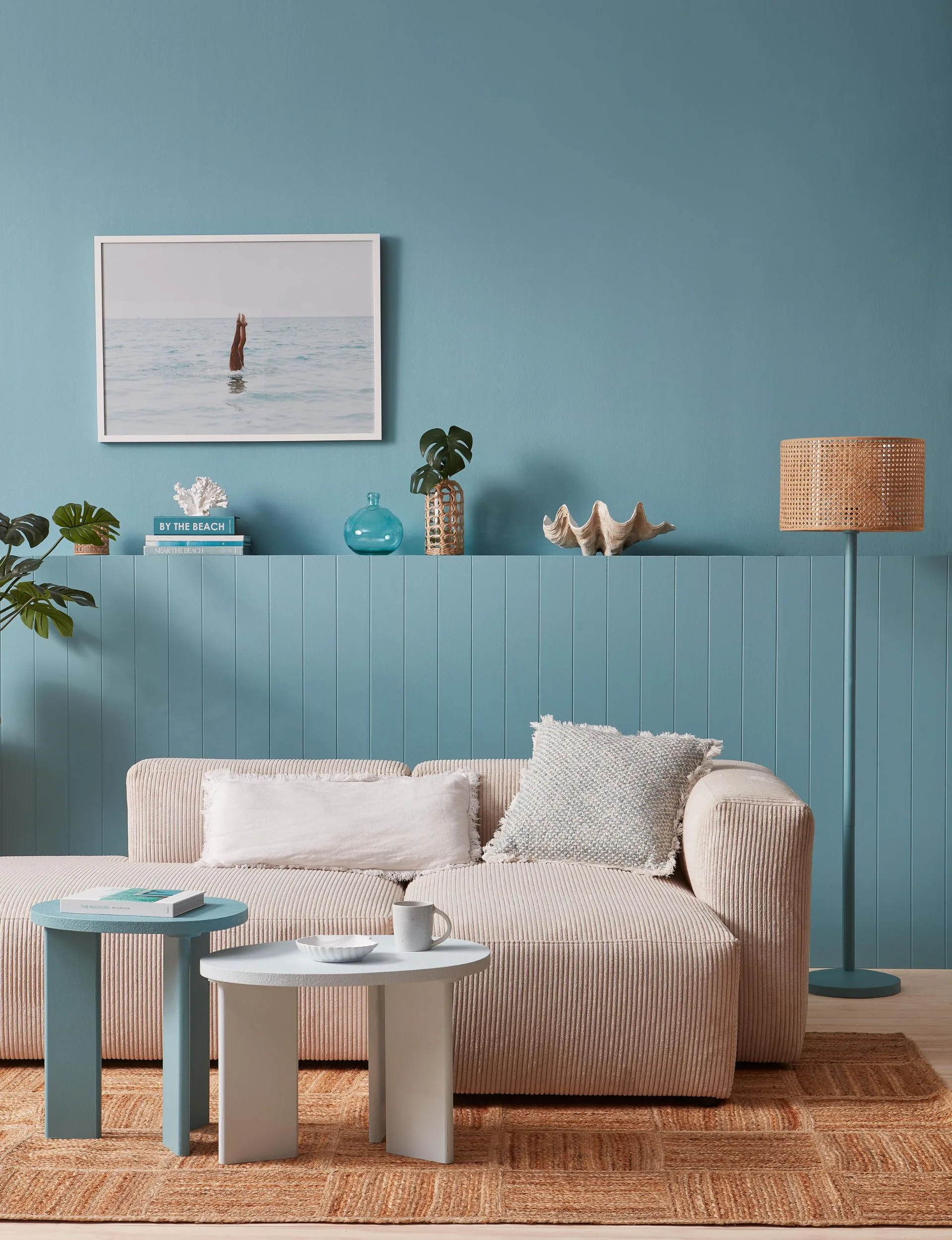 Bring the summery beach holiday vibe home with soothing blues and sandy neutrals. Walls painted in blue with neutral furniture