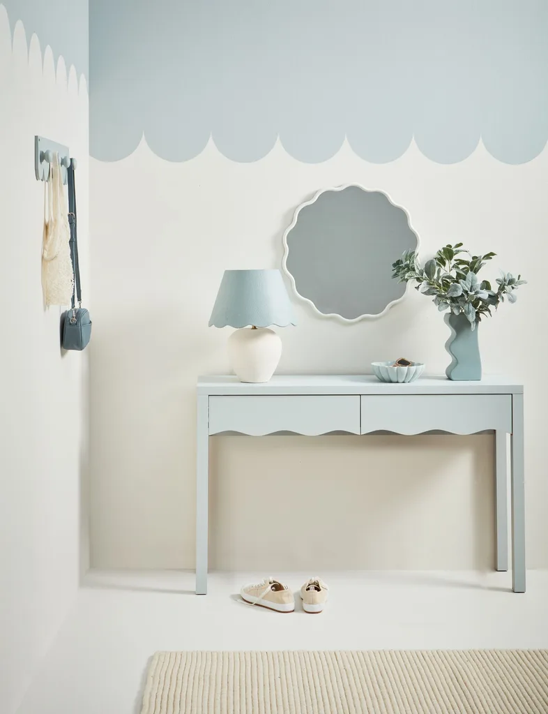 Bring the feeling of the sea back home from your holiday with scalloped edges on your wall using light blue paint