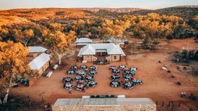 People enjoying an outdoor dinner at Alice Springs Telegraph Station