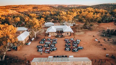People enjoying an outdoor dinner at Alice Springs Telegraph Station