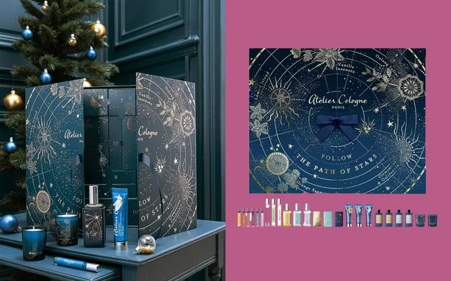 Ornate advent calendar with perfumes and candles on a dark table.