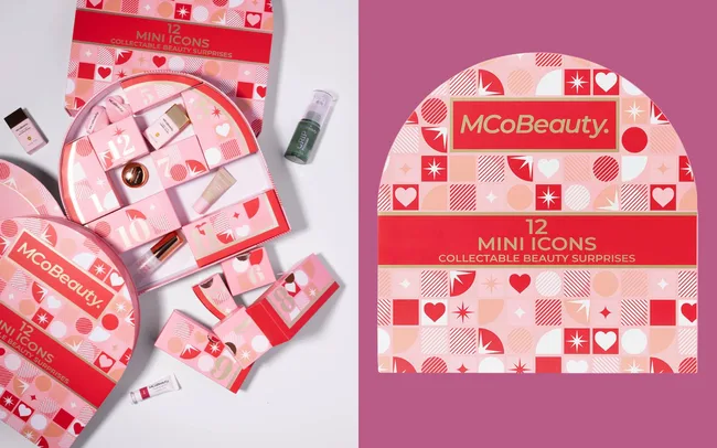 Red and pink advent calendar-style box with "MCoBeauty" branding and "12 Mini Icons Collectable Beauty Surprises" text. Open compartments reveal beauty products.