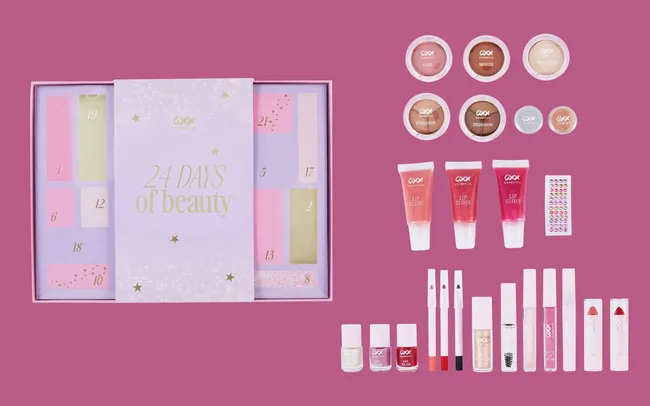 Advent calendar with "24 Days of Beauty" text, surrounded by various cosmetics including lip glosses, eyeshadows, lipsticks, and nail polish on a pink background.