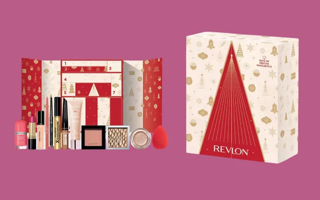 Revlon Beauty Advent calendar box with a festive design, featuring gold and red decorations. Opened to display beauty products like lipstick, mascara, and blush.