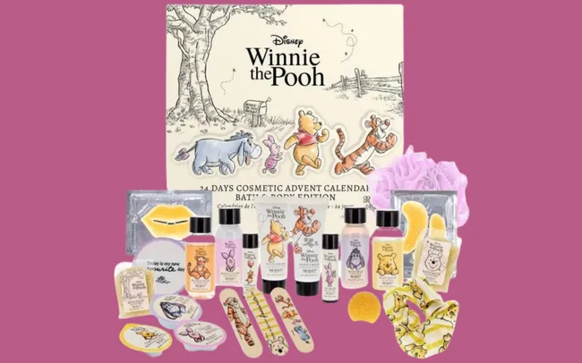 Winnie the Pooh-themed cosmetic advent calendar with body products and nail accessories against a purple background. Cheerful and playful tone.