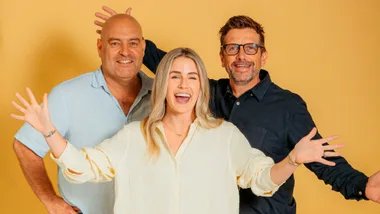 three people sanding together happy