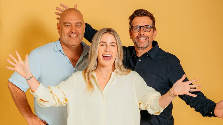 three people sanding together happy