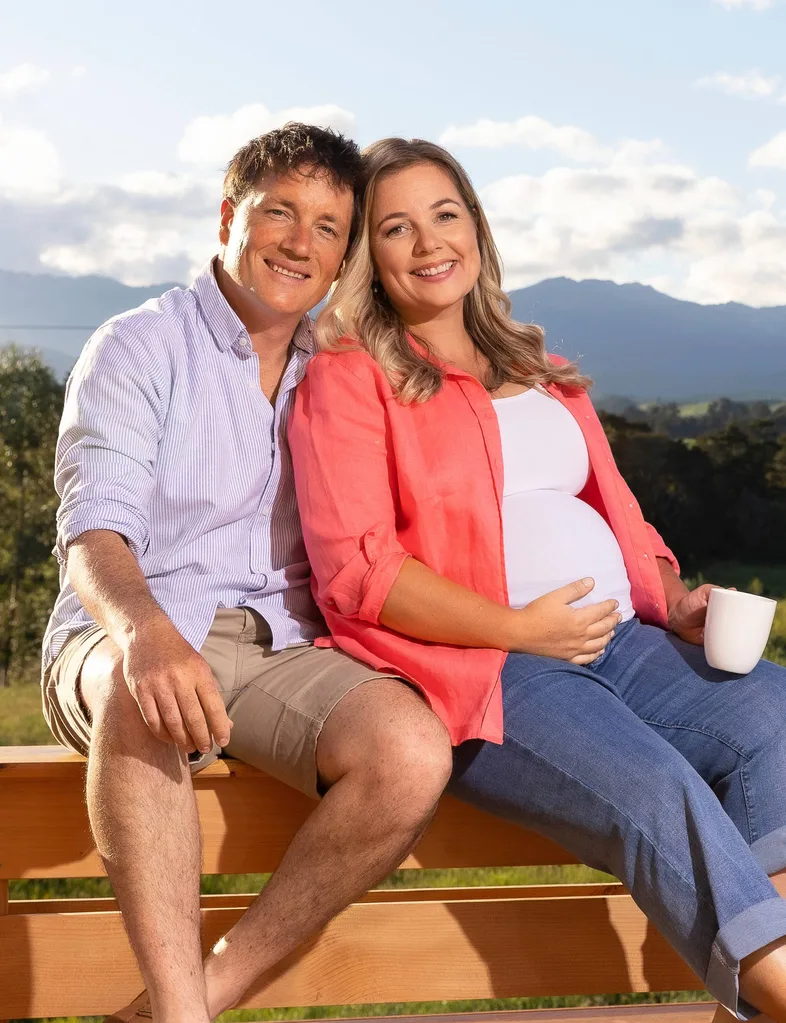 Alexa Cook and partner sat on bench in the sun
