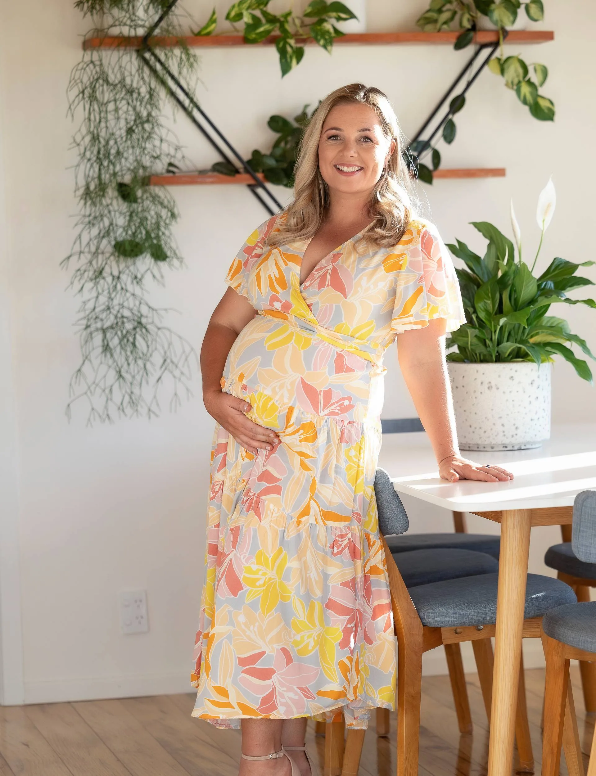 Alexa Cook in floral dress showing baby bump