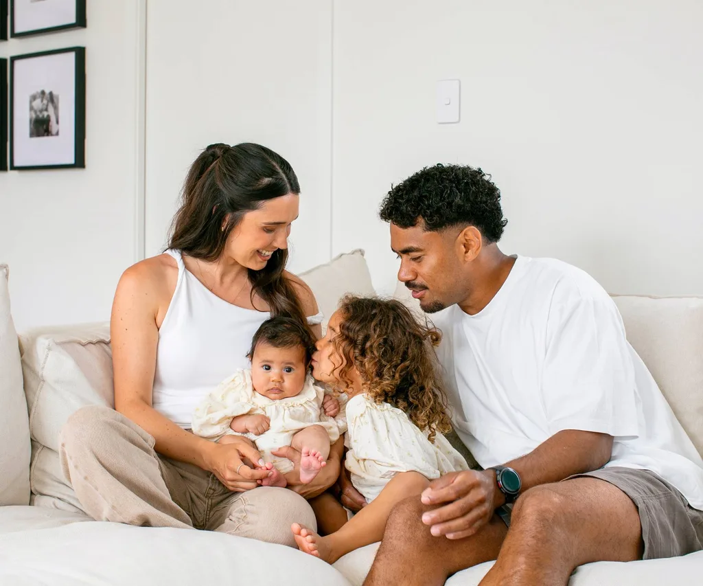 Emoni and family sharing kisses