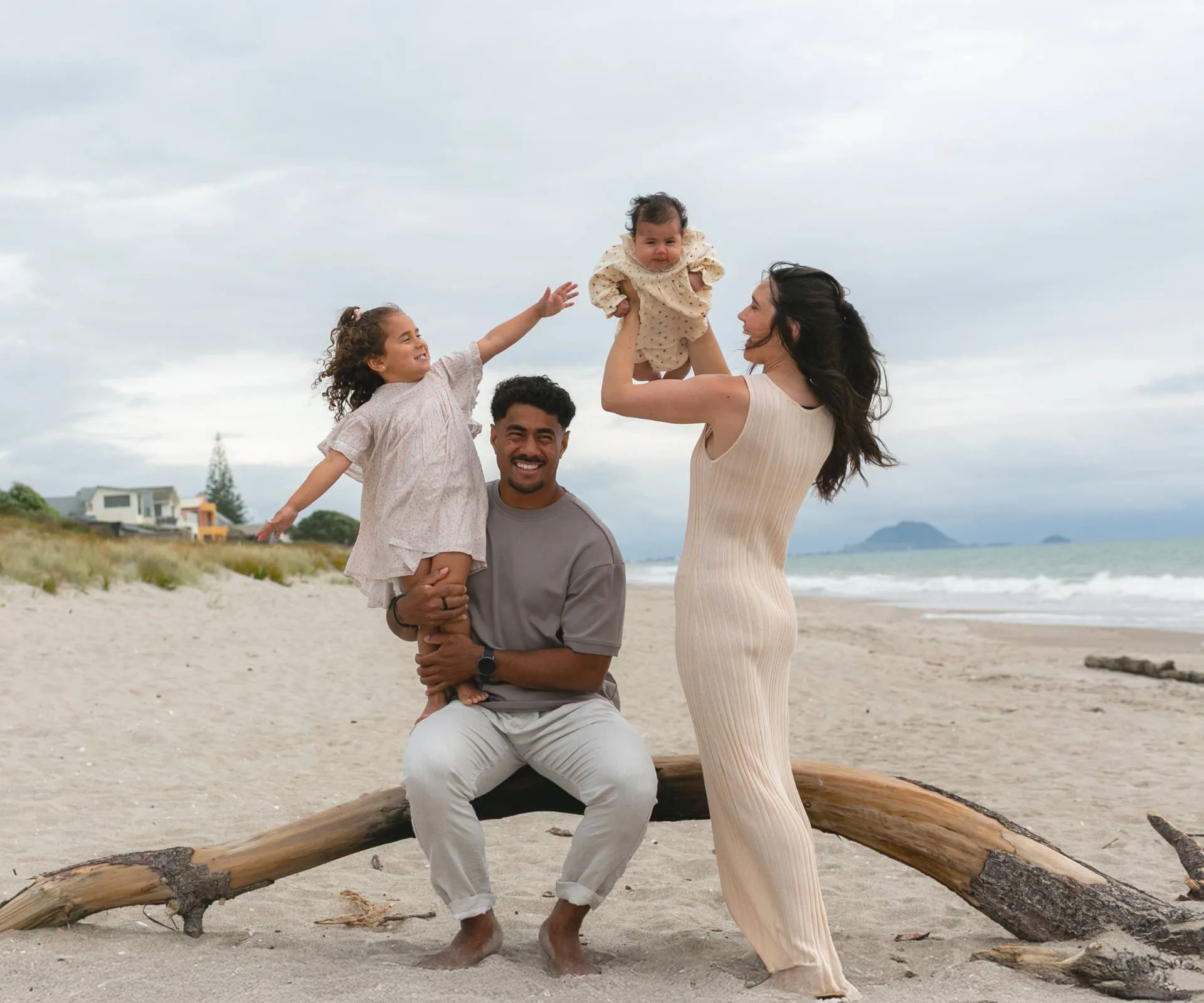 emoni and family playing on the beach together
