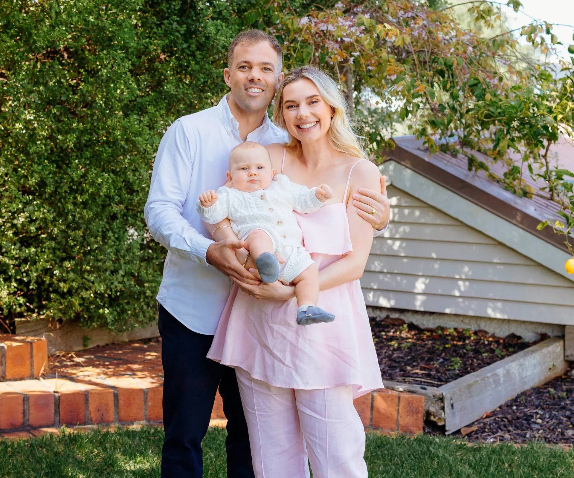 Caitlin Crisp with partner and son Charlie in the garden sun