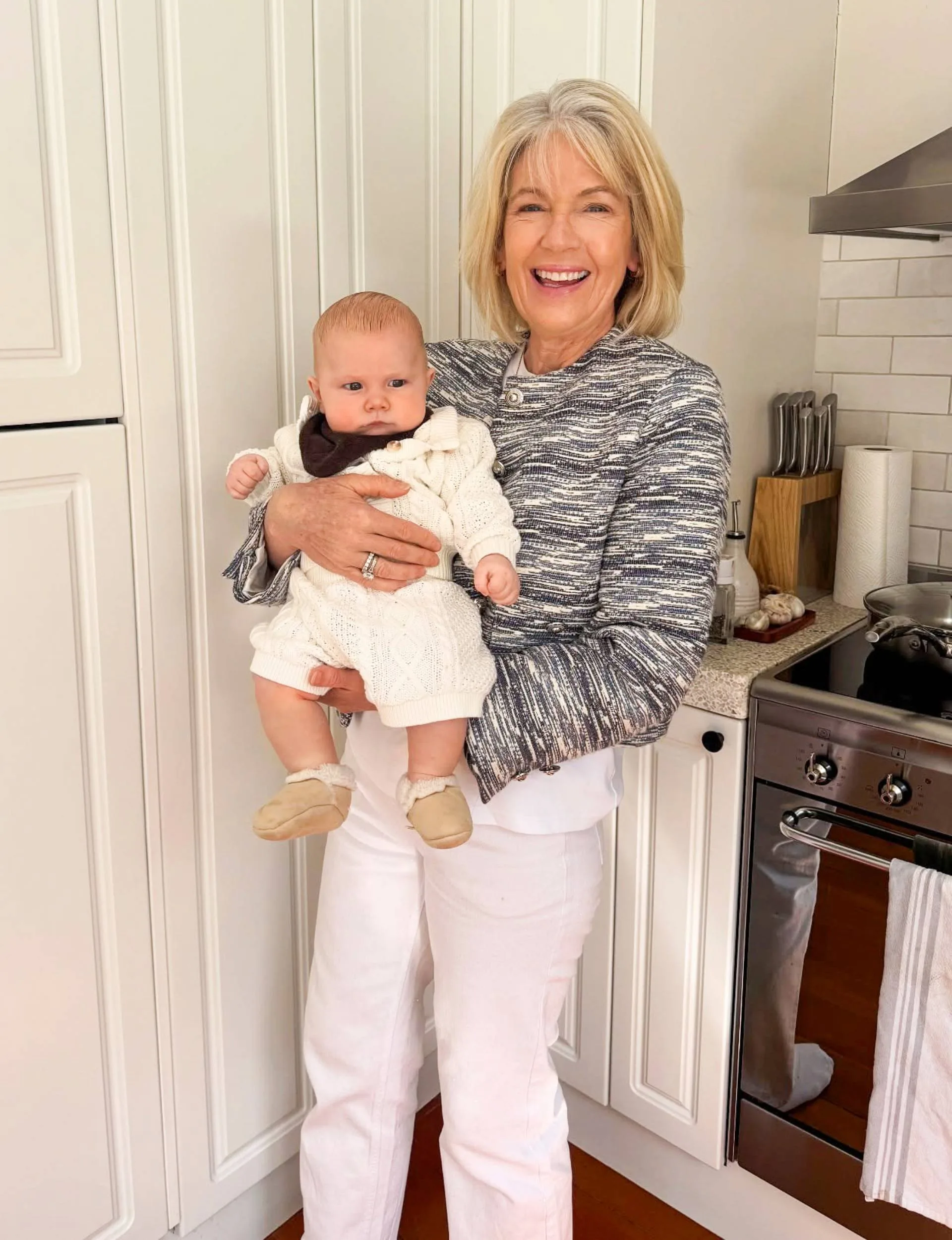 Grandma Karen holding baby Charlie in kitchen