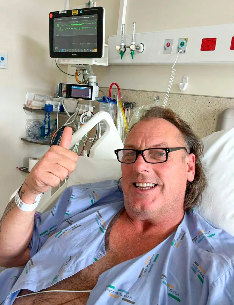 Kelvin in hospital bed showing monitor