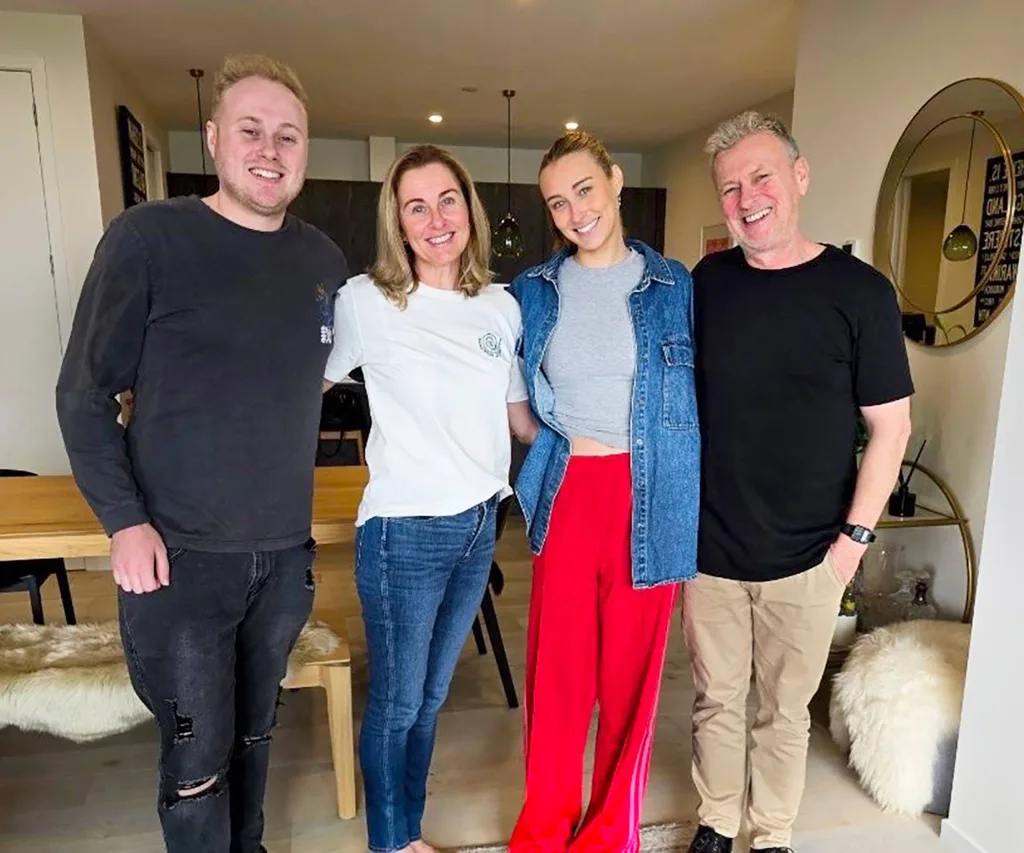 Family standing in lounge smiling