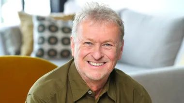 Man in green shirt smiling