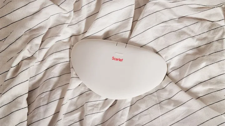 Scarlet heating pad on bedspread