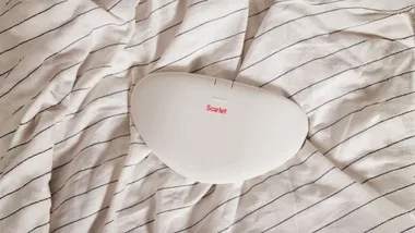 Scarlet heating pad on bedspread