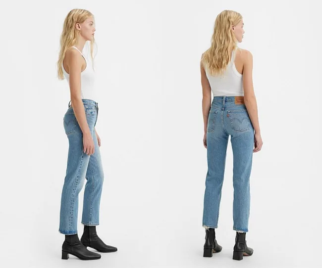 A side-by-side on-model shot showing front and back comparison of a medium blue pair of jeans, slim straight leg and cropped at ankle
