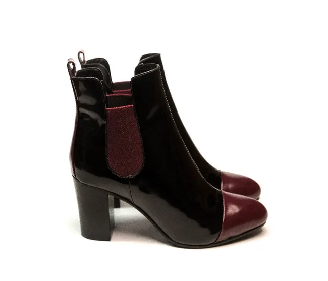 Black and burgundy ankle boots with block heels, side view.