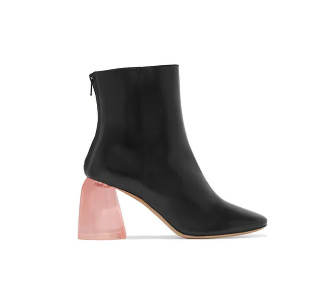 Black ankle boot with a chunky transparent pink heel, side view.