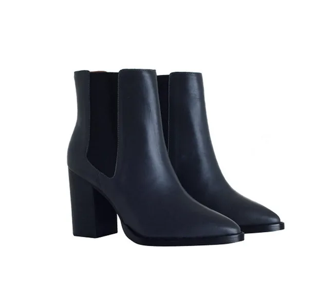 A pair of black leather high-heeled ankle boots with a sleek design and side elastic panels.