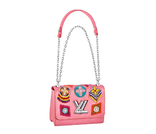 Pink Louis Vuitton handbag with colorful patches and silver chain strap.