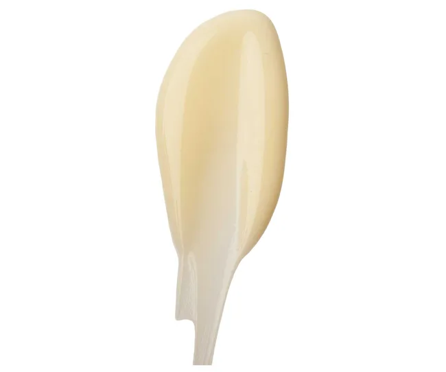Creamy sauce on a spoon against white background.