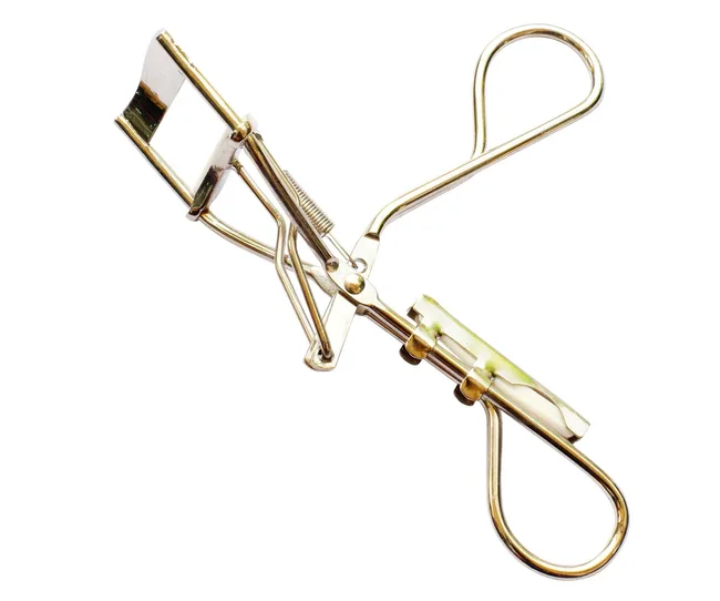 Eyelash curler with gold finish, featuring finger loops and a spring mechanism, isolated on a white background.