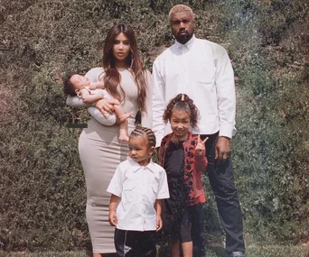 The truth behind Kim Kardashian’s gorgeous family pic – and why no one is really smiling
