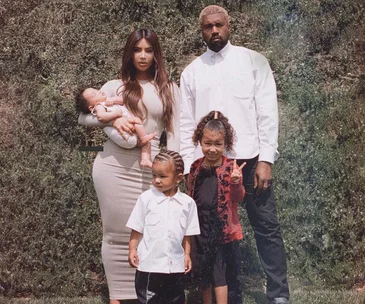 The truth behind Kim Kardashian’s gorgeous family pic – and why no one is really smiling
