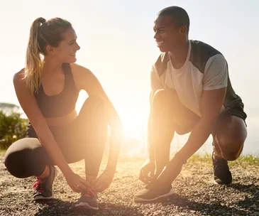 Couple tying shoelaces