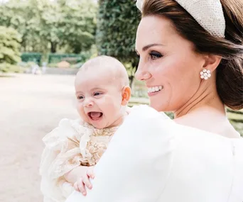 The royal family have released a candid christening photo of Prince Louis laughing