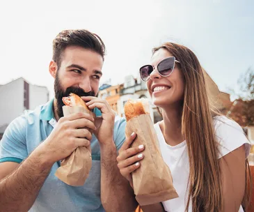 Couple eating baguettes