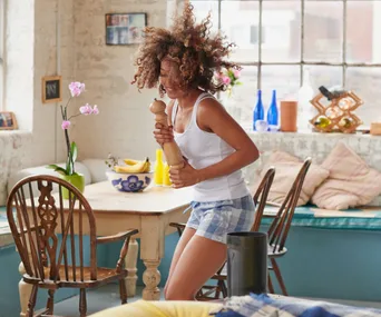 Single woman dancing in pyjamas