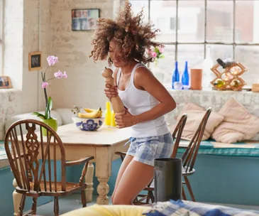 Single woman dancing in pyjamas