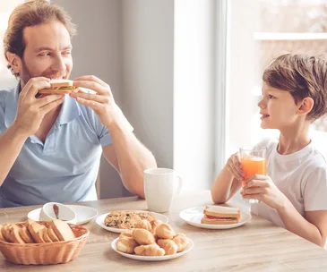 father and son eating breakfast