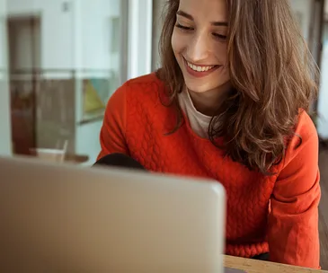 woman smiling at laptop