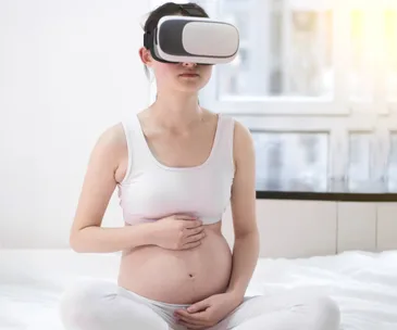Pregnant woman using virtual reality headset